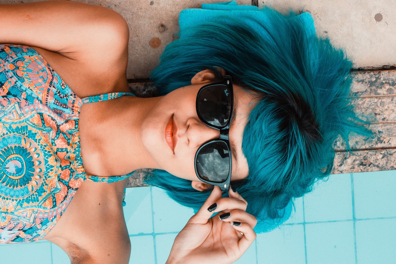 Woman wearing stylish trendy sunglasses outdoors on a sunny day